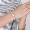 Women's polished white ceramic bracelet with magnetic gold edges