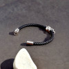 Bracciale da uomo in pelle intrecciata con teschio in acciaio