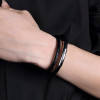 Bracciale uomo in pelle nera intrecciata con chiusura in acciaio