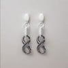 Boucles d'oreilles pendantes ceramique noire infini - paire