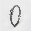 Bracciale da uomo in pelle intrecciata con teschio in acciaio nero