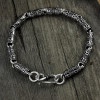 Men's silver cylindrical oxide bracelet with OM motif