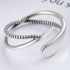 Silver open ring with infinite crossed lines